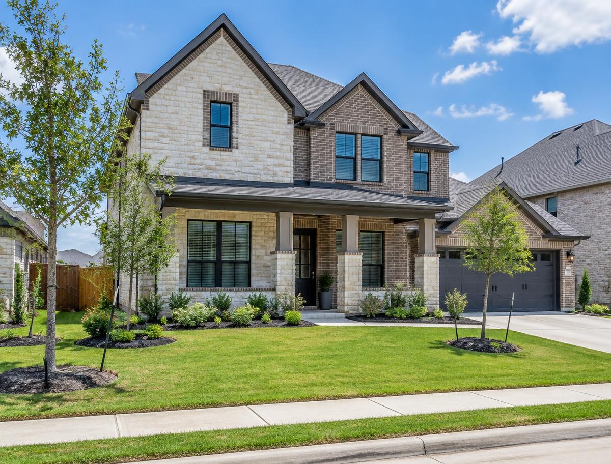 An upscale brick-and-stone home with a covered porch in a Cypress community