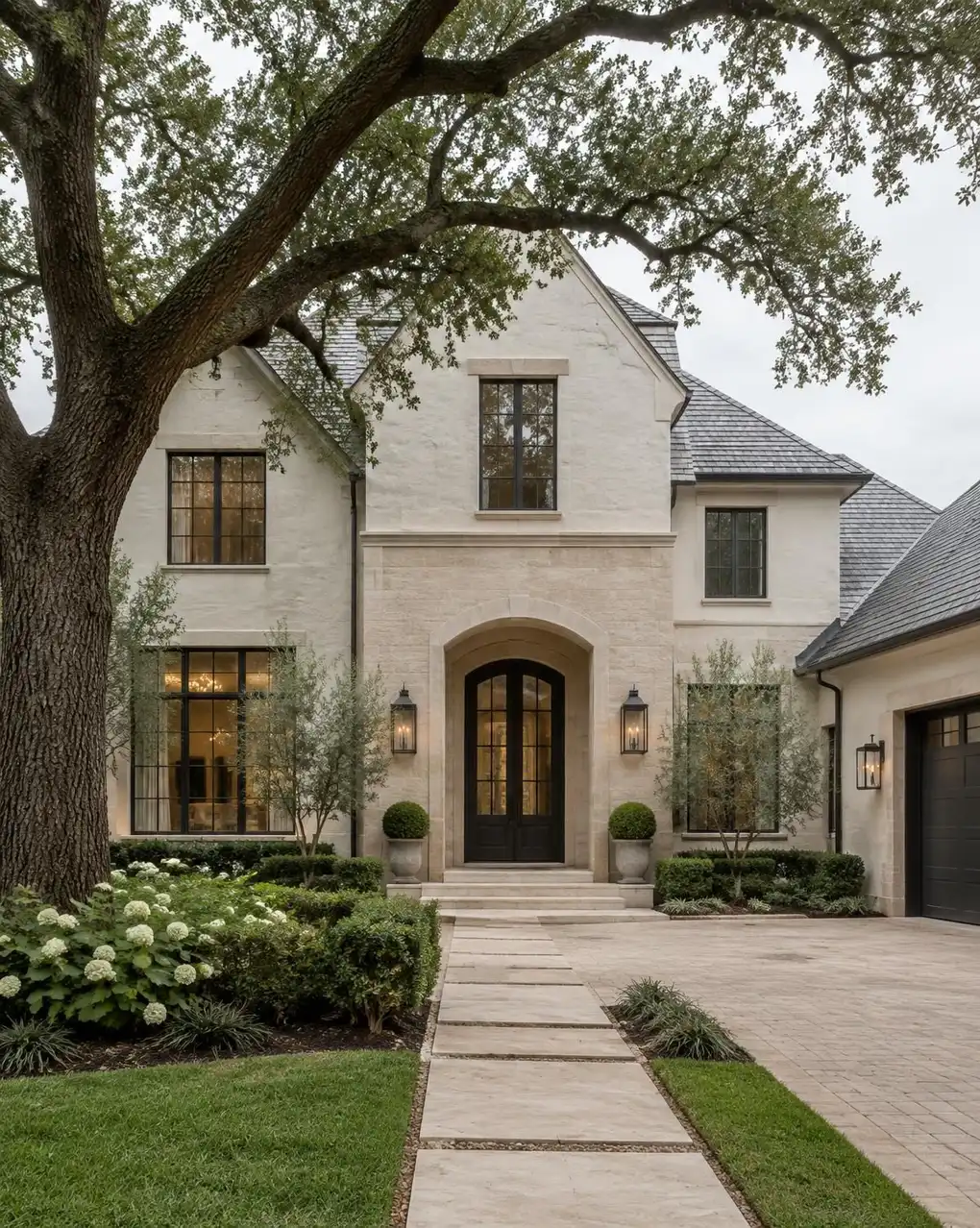 Elegant light stone home beneath a live oak in Houston